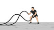© Nure - Man in black sportswear performing a battle rope exercise on a gray concrete floor against a plain white background for fitness training.