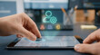 © SYATRI RAWU - Professional using a digital tablet and tactile dial to manage user settings and enterprise profiles with futuristic holographic icons in a modern office.