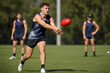 © Glenn - AFL Player Handballing During Practice Drill