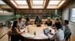 © INT888 - Business meeting roundtable office team discussion professional group round wooden table in modern glass boardroom with laptop, notebook, plant, skylight, diverse coworker
