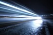 © Nelle - Streaking light trails on a wet, dark road create a sense of speed