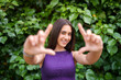© Westend61 - Smiling girl making framing gesture with hands outdoors in garden