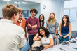 © unai - Diverse students collaborating and discussing ideas in modern classroom