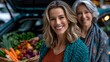 © COK House - Two smiling women display fresh produce in a car trunk background, highlighting community support and healthy living.