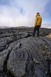 © Mara Brandl/imageBROKER - Tourist standing on petrified lava, volcanic stone in bizarre shapes, lava field, volcanic eruption, active table volcano Fagradalsfjall, Krýsuvík volcanic system, Reykjanes Peninsula, Iceland