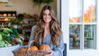 © dinatychynska - Smiling shopper holding pumpkin basket at organic grocery entrance, autumn harvest shopping, Halloween preparation, Thanksgiving season vibe, fresh local produce, cozy holiday meal planning.