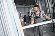 © Serhii - Worker carrying pvc window profile in factory workshop