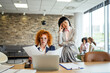 © Miljan Živković - Stressed businesswomen discussing documents in a modern office