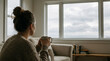 © Swayam - woman sitting on sofa holding coffee mug with adult female
