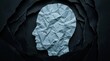 © Umnat - Silhouette of a depressed and anxious person's head made of crumpled paper.