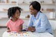 © Prostock-studio - Smiling Black Mother With Daughter Playing Together With Colorful Building Blocks At Home, Encouraging Creativity And Bonding In A Cheerful Atmosphere. Family Lifestyle Concept.