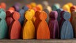 © Nasreen - Backlit multicolored wooden human figurines representing diversity, inclusion, teamwork and social unity, symbolic community population concept with equality, leadership, collaboration and belonging,