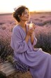 © Cahya - Serene free-spirited woman in a lavender dress closing her eyes while holding a perfume bottle in a lavender field, evoking calming tranquility and organic aroma