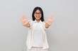 © ArvStd - Happy and beautiful Asian girl smiling, showing ten fingers to explain the rules and steps, standing on a white background.