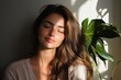 © Thanapong - Woman portrait natural makeup soft light neutral tone brown hair closed eye calm expression house plant indoor scene beauty