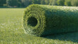© RUTTAMPUBOLON - Roll of artificial green grass turf on a manicured lawn under sunlight