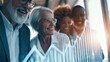 © Selvi - Diverse group of senior business professionals reviewing data charts with smiles in a office