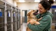 © Micevic family - Happy volunteer woman hugging a rescue dog at animal shelter