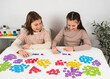 © Jan - Group of smart children playing linguistic dominoes game at home desk. Interactive elementary school learning process focusing on literacy, spelling, logic and speech therapy.