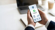 © dody - Secure mobile payment application on a smartphone, user holding device with verified transaction success on screen