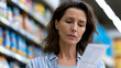 © Jane_S - Woman reading product label while shopping in supermarket aisle