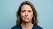 © Adil - Portrait of an adult woman with facial muscle weakness and asymmetry wearing blue medical scrubs