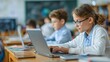 © ek - Children Learning Technology in Classroom Environment with Laptops