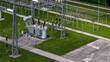 © 24K-Production - Aerial view of an operational electrical substation with transformers and high-voltage equipment for power distribution.