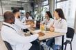 © anatoliycherkas - Diverse medical team collaborating on healthcare discussion in modern hospital meeting room