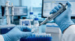 © Nataly - Laboratory technician uses micropipette to transfer liquid samples in modern lab environment. The lab setup includes various scientific equipment like tubes and bottles.