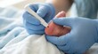 © l1gend - Infant's heel being pricked with a lancet for newborn blood screening test
