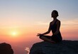 © oksa_studio - Yoga silhouette of a woman in meditation on a rocky cliff during a sunset peace