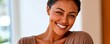 © Georgii - Warm indoor close-up portrait of a smiling woman radiating confidence and natural beauty