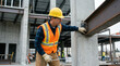 © 123sasha - Construction worker inspecting steel beam on site