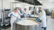 © 123sasha - Dairy workers stirring cheese in factory vat