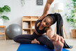 © Kawee - African American sportswoman doing yoga workout in living room at home.