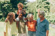 © Carlo Prearo - Diverse multigenerational family enjoying time together outdoors