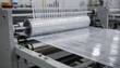 © DigitalSpace - Medium shot of log slitter machine slicing wide film rolls into precise narrow strips with smooth controlled tension for efficient material conversion in industrial settings.