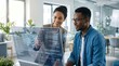 © Hao - Two diverse business professionals analyzing futuristic holographic data interface, digital transformation concept, AI technology in modern office workplace