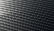 © Connect Images - Close-up of woven carbon fiber texture in a gradient light setting.