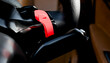 © Connect Images - Close-up of a car interior with a bright red paddle shifter on the steering wheel.