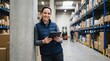 © TheseusStock - Smiling Female Logistics Manager Using Digital Tablet for Inventory Tracking in Large Modern Distribution Warehouse