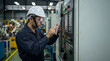 © thaismile - Industrial operator using tablet at CNC machine console