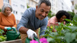 © Mary - Community gardening volunteers planting seedlings outdoors