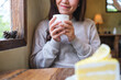 © Farknot Architect - Closeup image of a woman drinking coffee and eating a lemon cake in cafe