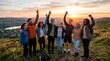 © Sofia - Diverse group of friends enjoying sunset hike with raised hands celebrating success