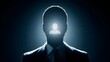© VisualNest - Silhouette of a man in formal wear with a glowing human icon radiating from his head representing concepts of identity personal recognition and inner self or projected image in a dark mysterious