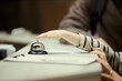 © DragonImages - Close up of child hand reaching and pressing hotel reception bell while family checking in at front desk. Ideal for travel booking, hospitality service, family vacation marketing