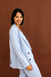 © Tania Cervian/Stocksy - Woman in light blue suit smiling