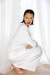 © Tania Cervian/Stocksy - Woman crouching in white suit